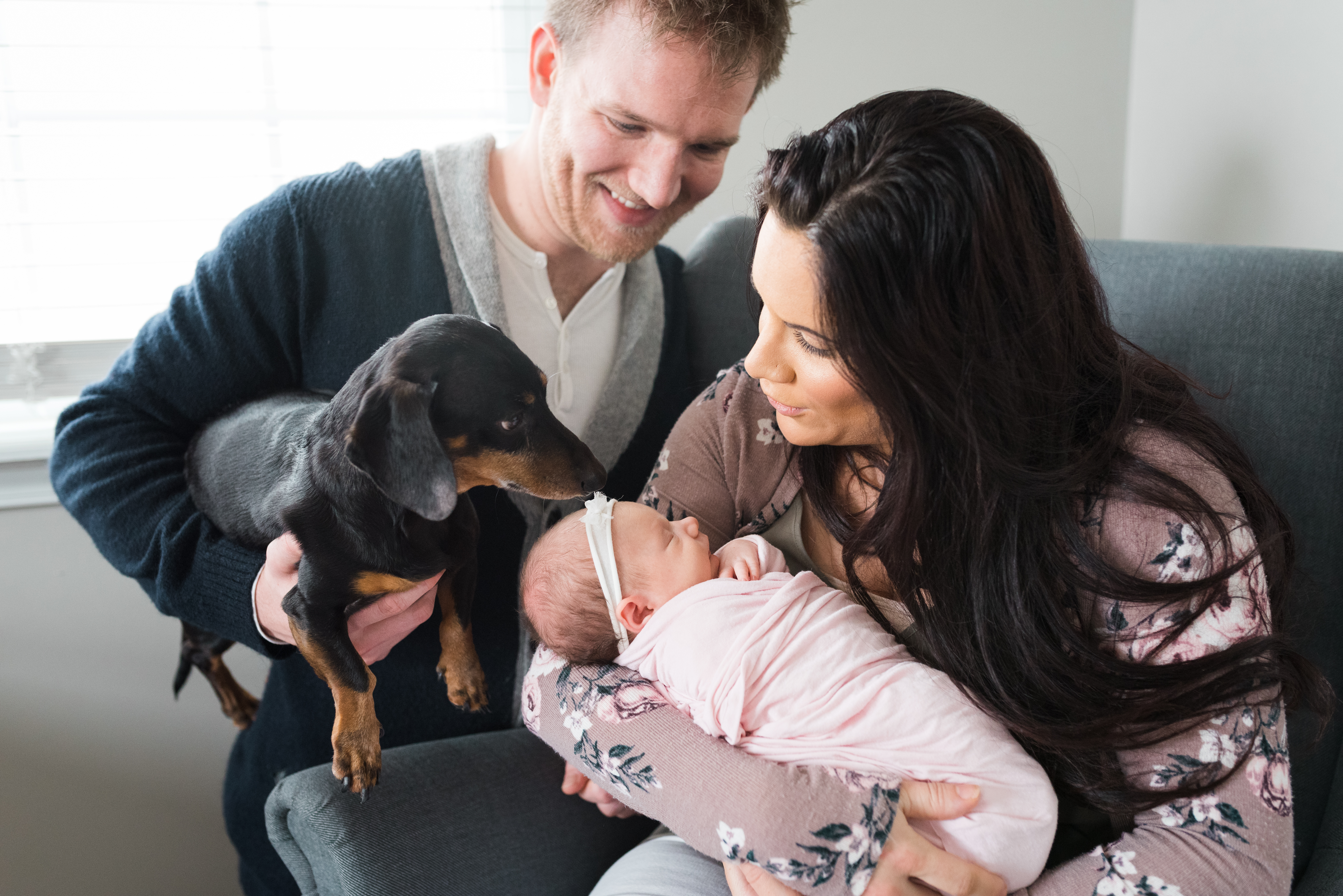 Parents with newborn baby and dog
